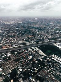 Aerial view of city and buildings against sky