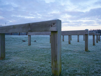 Wooden structure on beach against sky