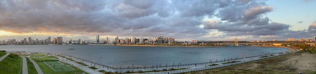 Panoramic view of river and buildings against sky during sunset. kazan, russia 