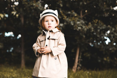 Portrait of cute girl standing at park