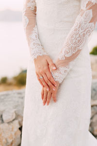 Midsection of couple holding hands