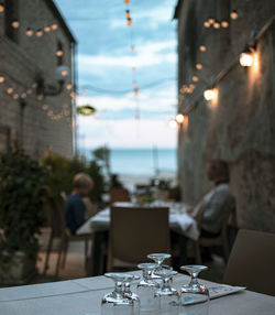 Glass of illuminated restaurant on building