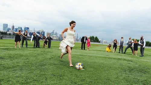 People playing soccer on grassy field