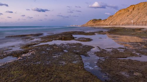 View of beach against cloudy sky