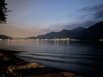 Scenic view of lake against sky at sunset