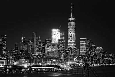 Illuminated buildings against sky at night