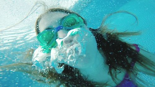 Close-up of woman swimming in pool