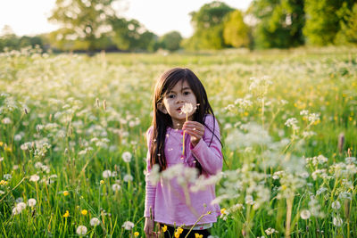 Portrait of girl standing on field