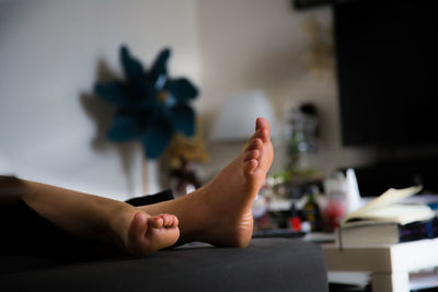 Low section of woman sitting at home