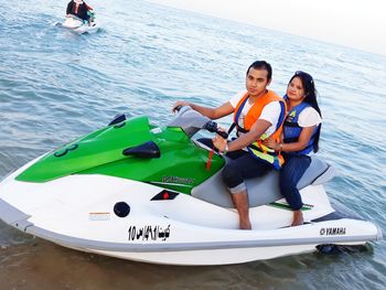 Friends sitting on boat in sea