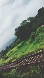 Scenic view of mountains against cloudy sky