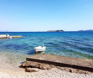 Scenic view of sea against clear blue sky