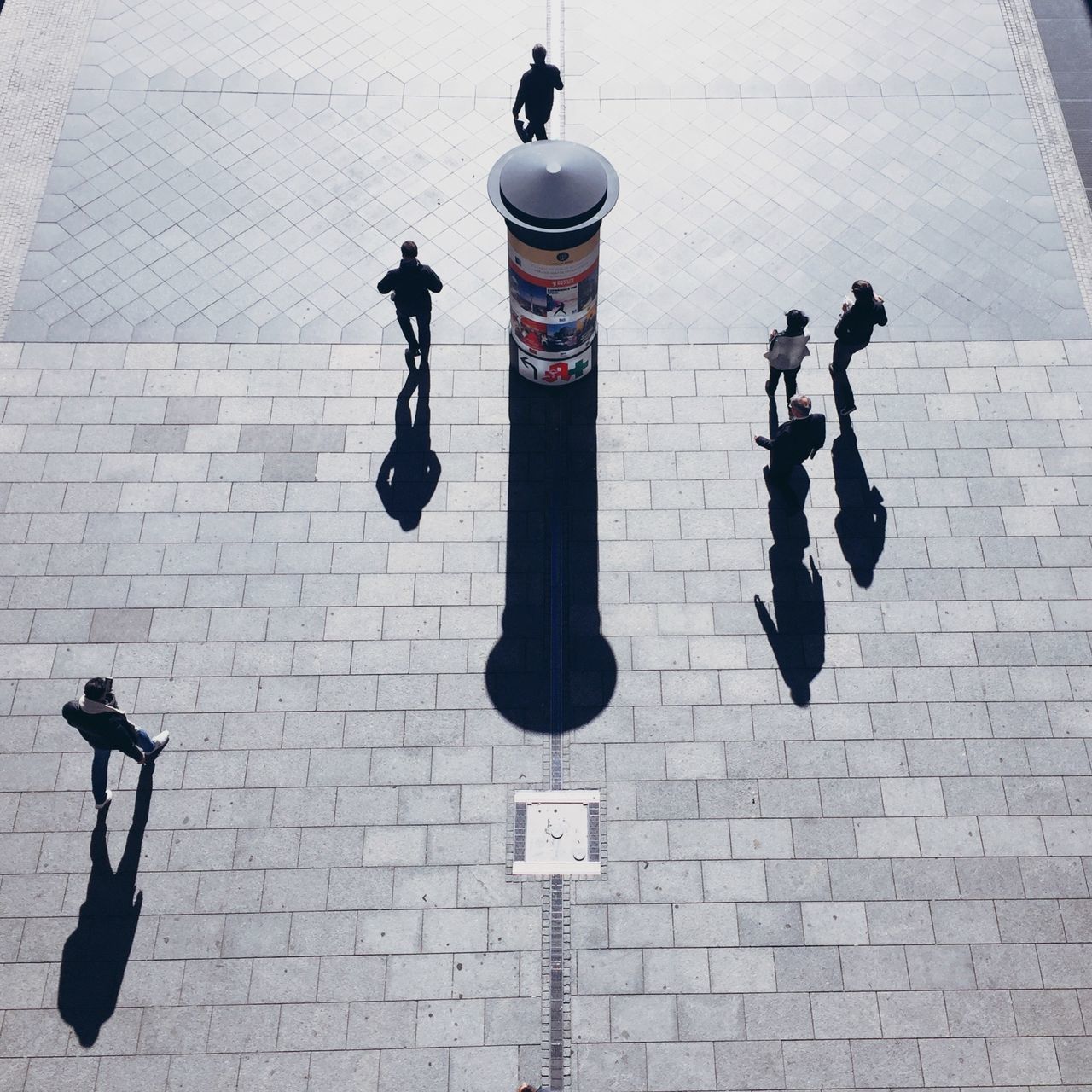 men, walking, shadow, leisure activity, lifestyles, sunlight, high angle view, person, city life, outdoors, footpath, vacations