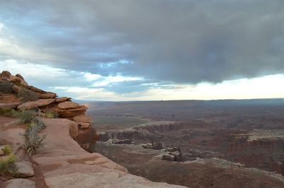 Rock formations in canyon against cloudy sky