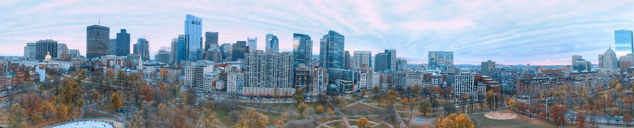 View of cityscape against cloudy sky