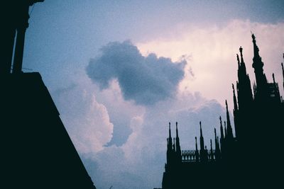 Low angle view of silhouette city against sky