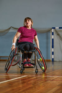 Portrait of young woman sitting on wheelchair