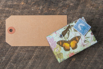 Directly above shot of label and diary on wooden table