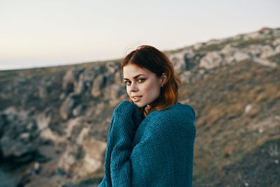 Portrait of young woman standing outdoors