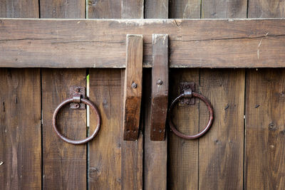 Vintage door knobs on the door. ancient pens in the form of rings from metal. close up.