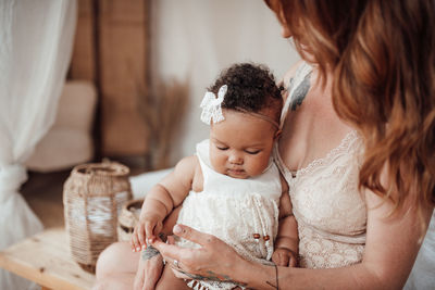 Mother and baby girl with arms raised