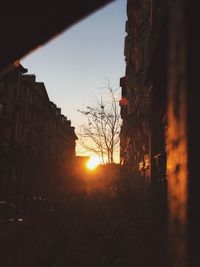 Silhouette buildings against sky during sunset