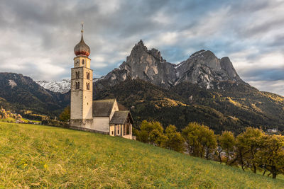 Historic building by mountains against sky