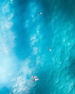 Aerial view of people surfing in sea