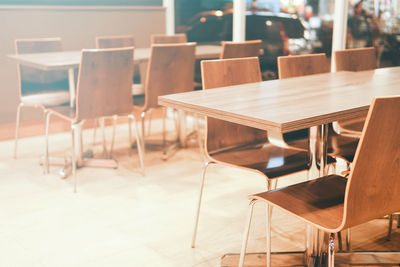 Empty chairs and tables in cafe