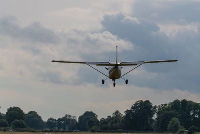 Low angle view of airplane flying against sky