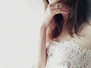 Midsection of woman by window