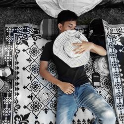 Portrait of a smiling young man sitting on bed