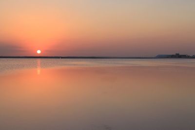 Scenic view of sea against orange sky