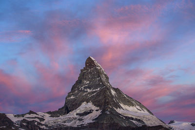 Low angle view of snowcapped mountain against sky during sunset