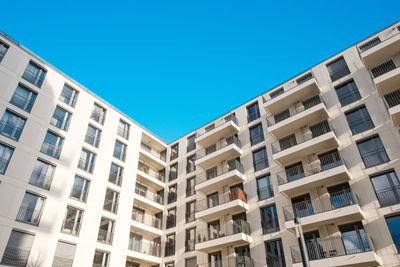 Low angle view of buildings against clear blue sky