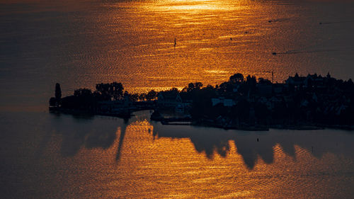 Dramatic sunset over lindau island with hard shadows on lake constance seen from eichenberg.