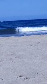 Scenic view of beach against clear sky