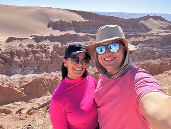 Portrait of woman wearing sunglasses while standing on mountain