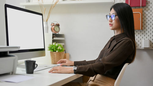 Side view of woman using mobile phone