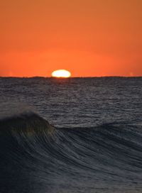 Scenic view of sea against orange sky