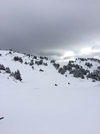 Scenic view of snow covered mountains against sky