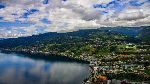 Aerial view of river amidst buildings against sky