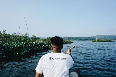 Rear view of man standing against sky