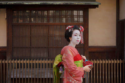 Woman standing against the wall