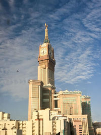 Low angle view of building against cloudy sky