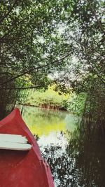 Boat moored by lake against sky