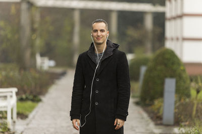 Portrait of smiling young man standing outdoors