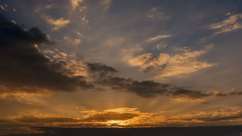 Low angle view of dramatic sky during sunset