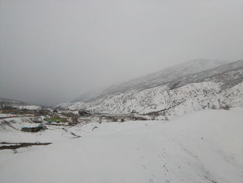 Scenic view of mountains against sky during winter