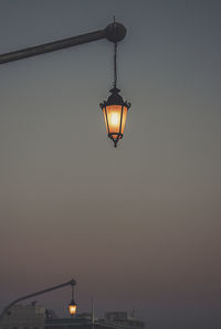 Low angle view of illuminated street light against sky